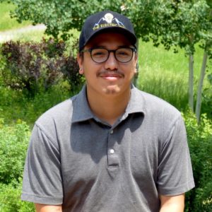 Team member wearing glasses and hat with company logo, included in electrical team images in Colorado Springs.
