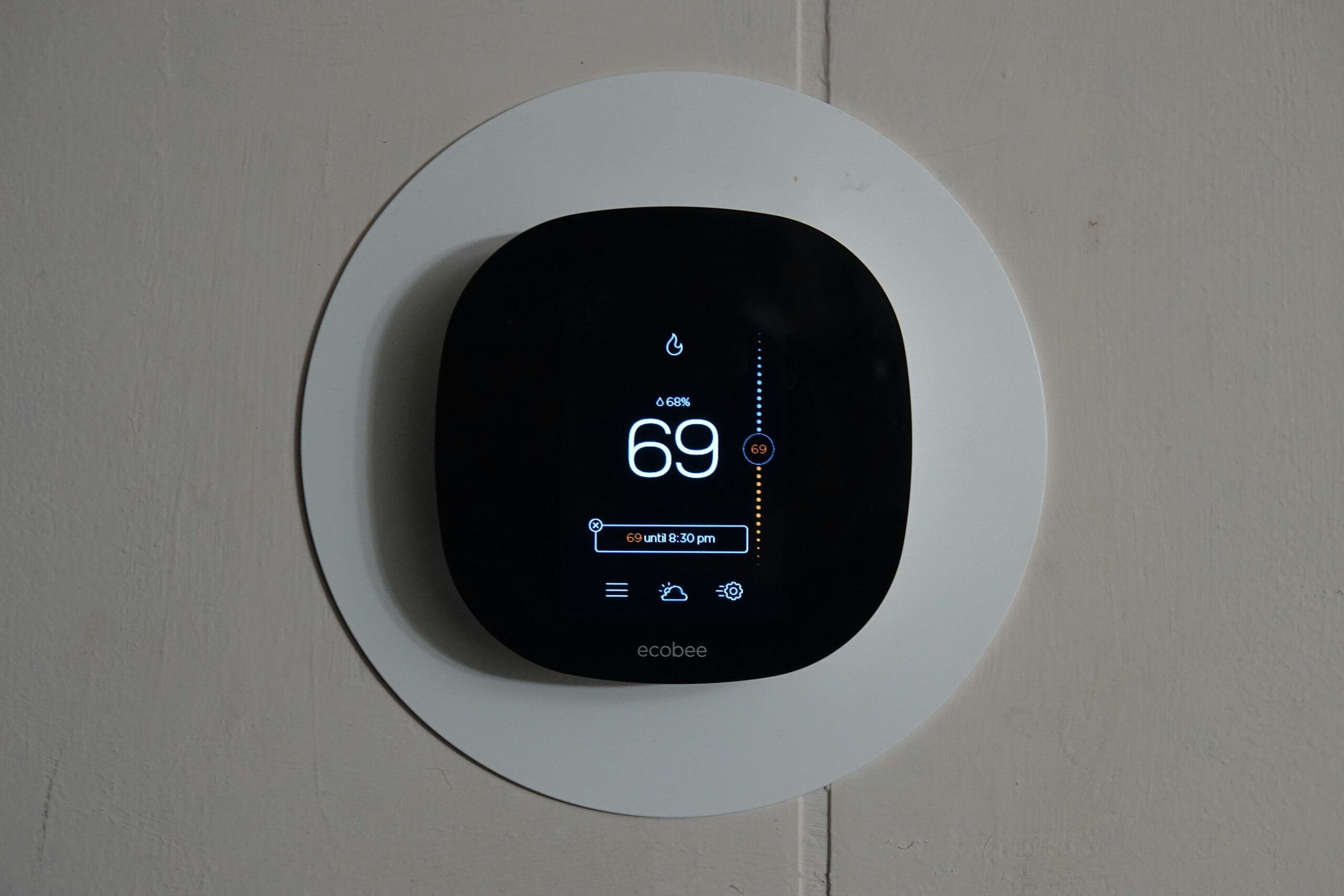 Smart thermostat installed on wall by smart home installer in Colorado Springs for energy-efficient temperature control.